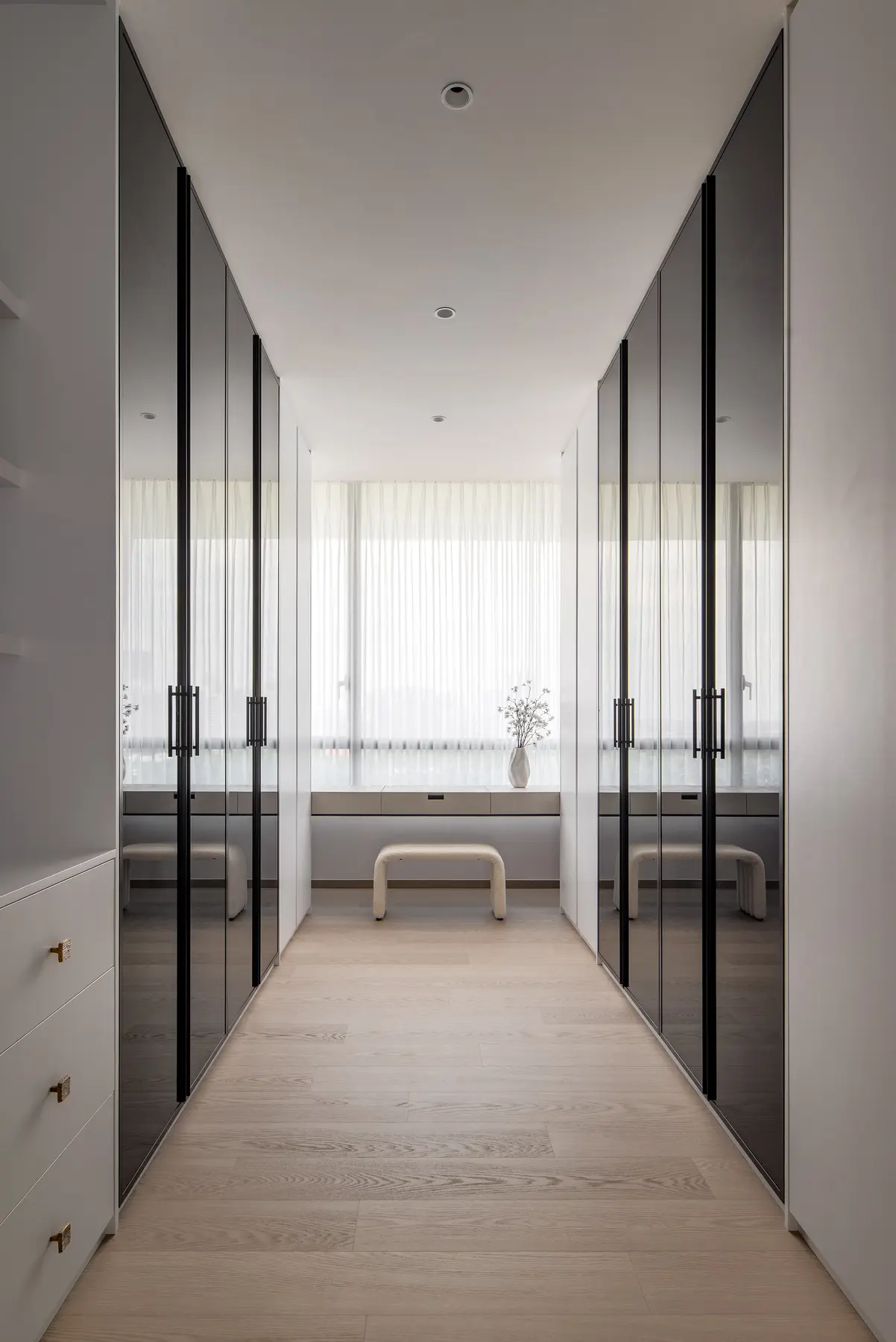 Walk-in wardrobe — full-height mirror doors and floating dressing table