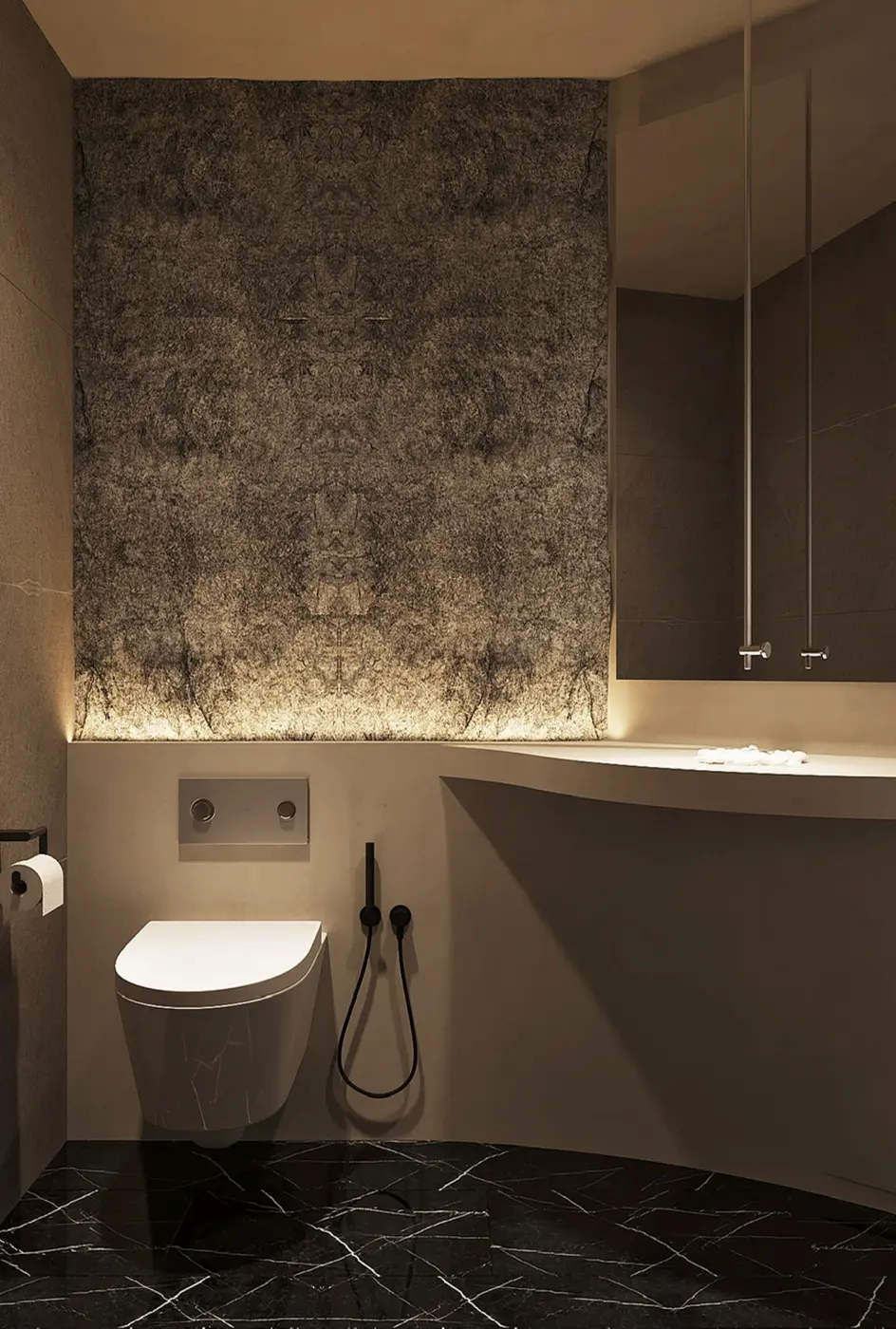 Powder room — dark stone feature wall with concealed glow lighting