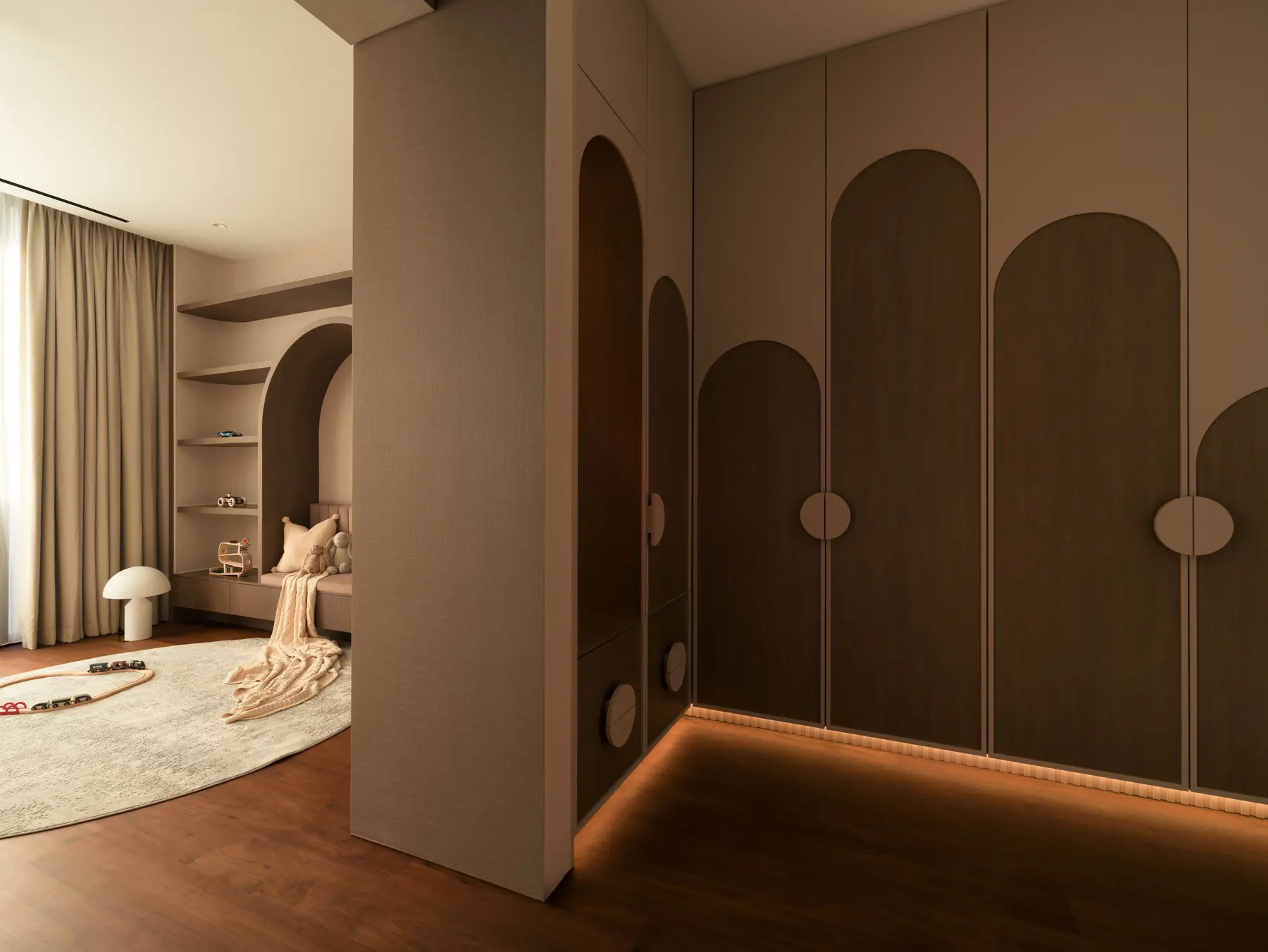 Children's room — wardrobe with arch-shaped door panels and warm glow underlighting