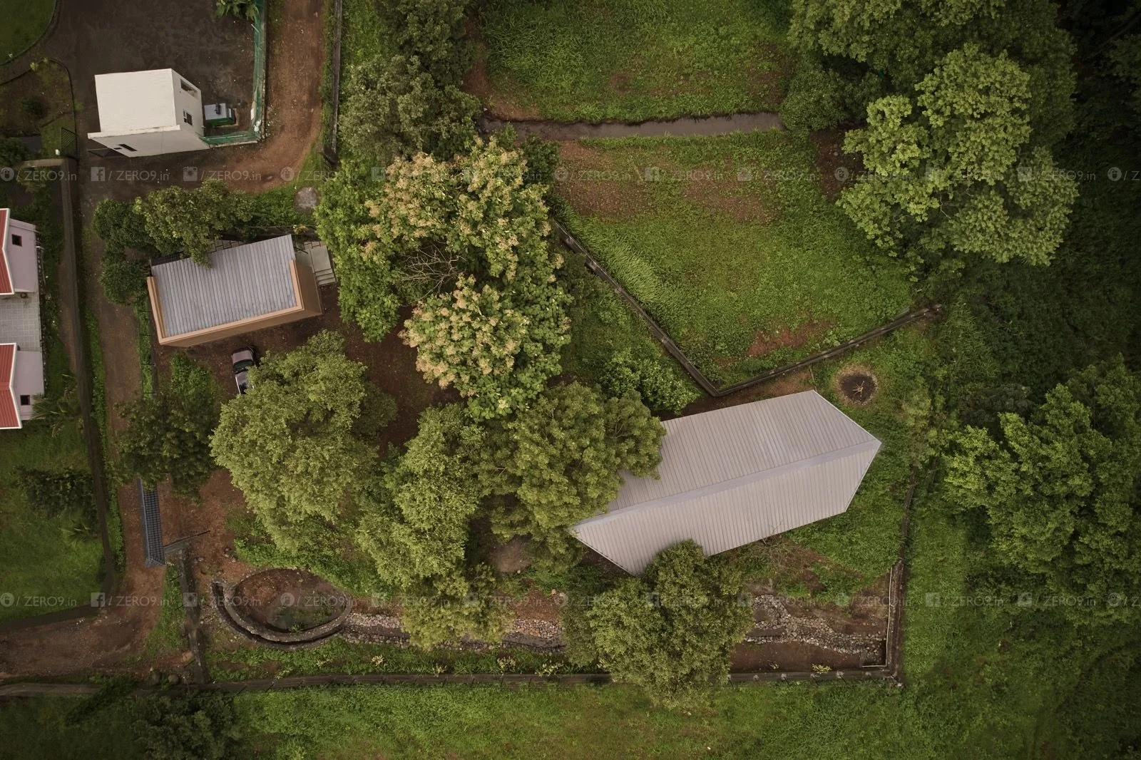 farmPAD exterior — sloping insulated roof, steel structure, trees in foreground